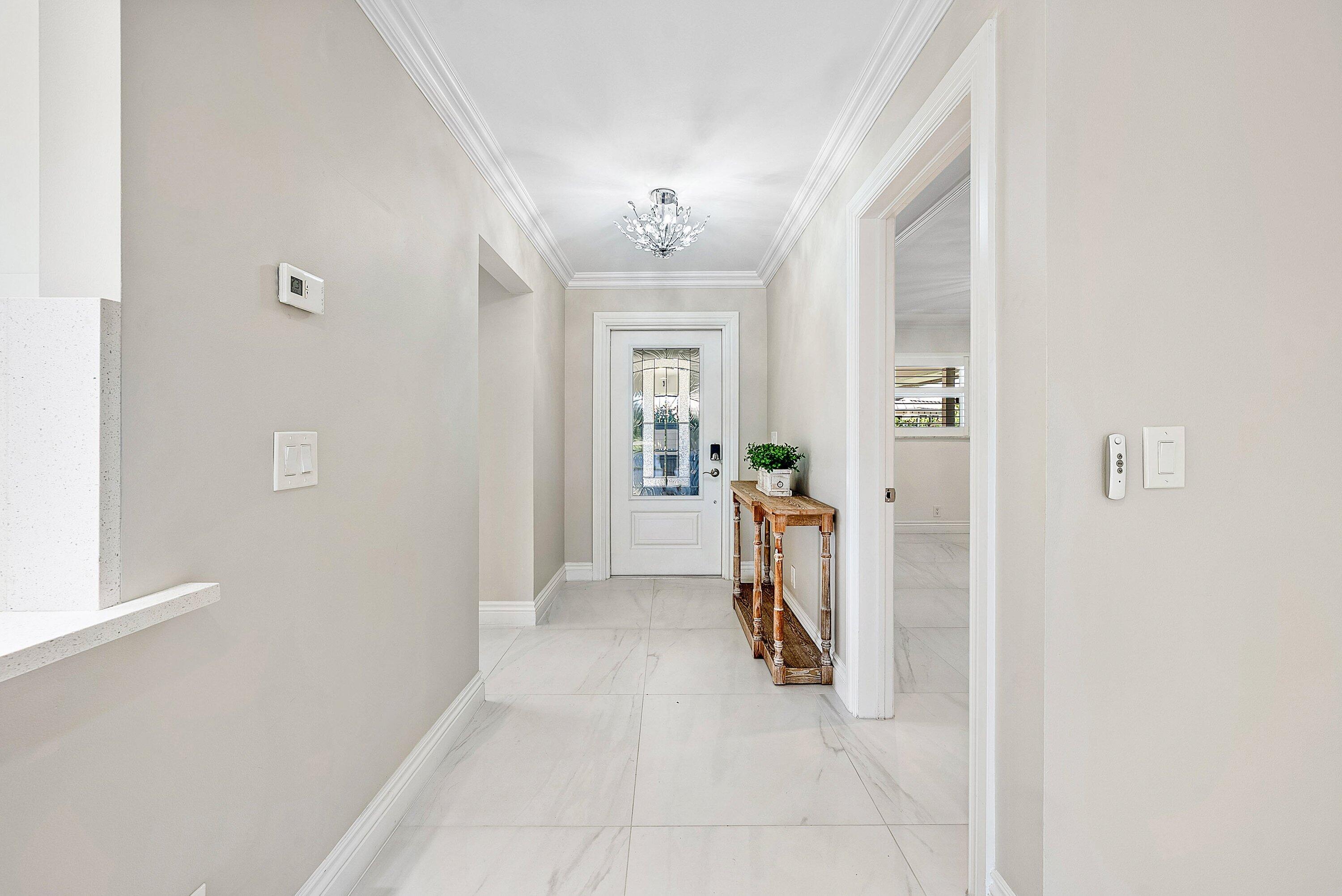 322 Cedar Key Circle Atlantis, FL 33462 - Photo 7 of 55 a view of a hallway with a furniture and a livingroom