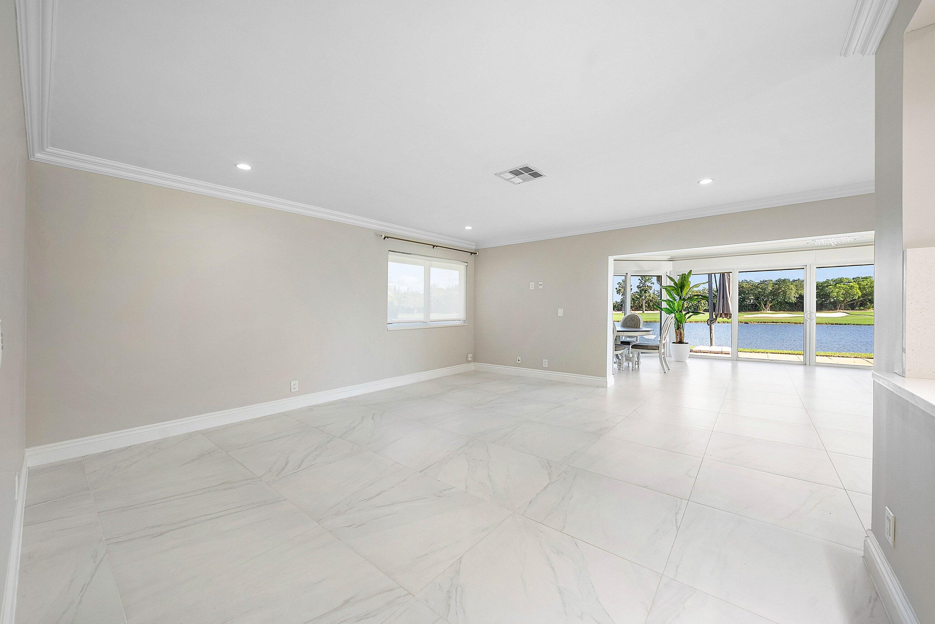 322 Cedar Key Circle Atlantis, FL 33462 - Photo 8 of 55 a view of an empty room with a window