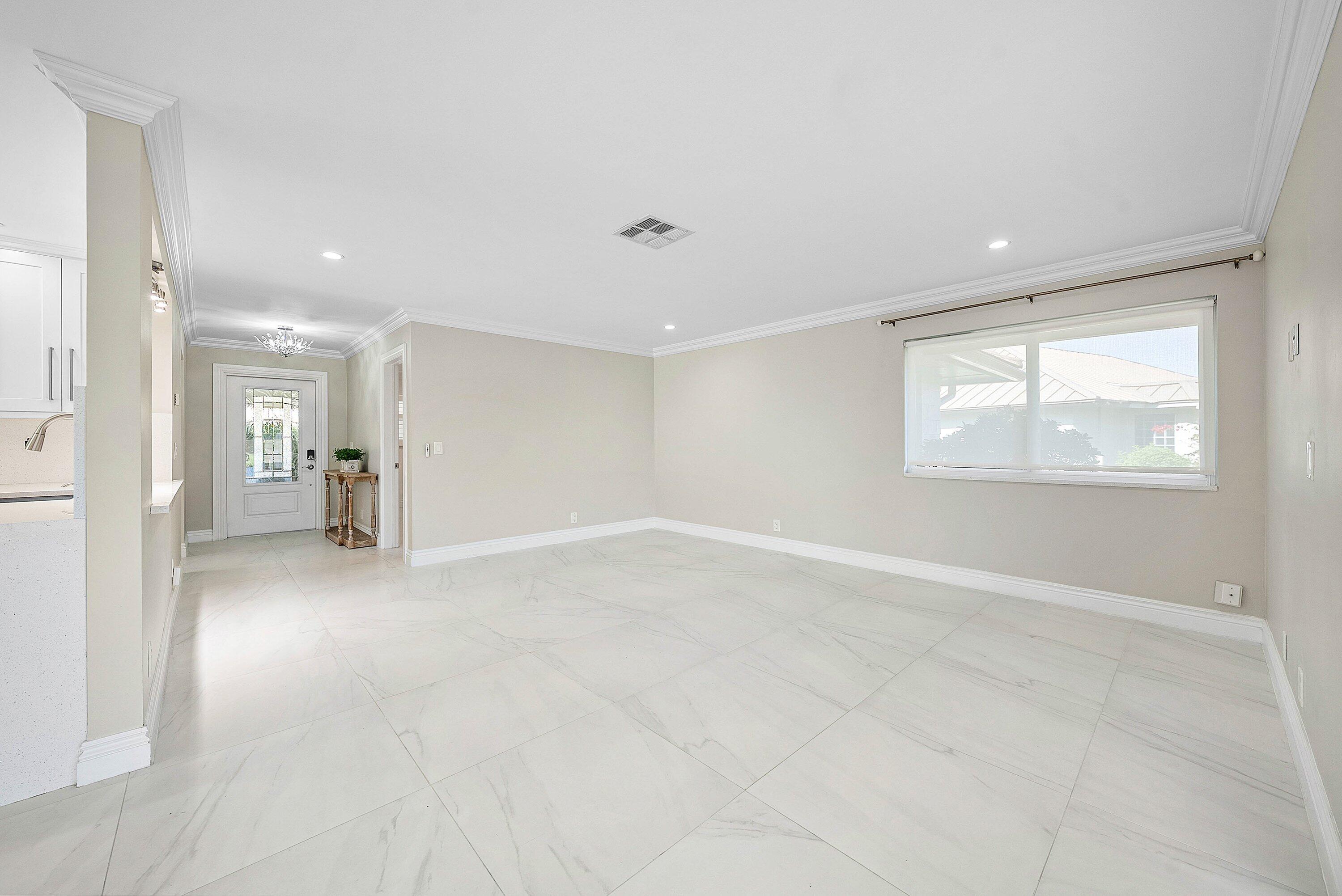 322 Cedar Key Circle Atlantis, FL 33462 - Photo 9 of 55 a view of empty room with wooden floor and fan