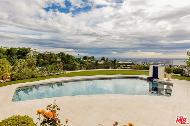 a view of swimming pool with outdoor seating and plants