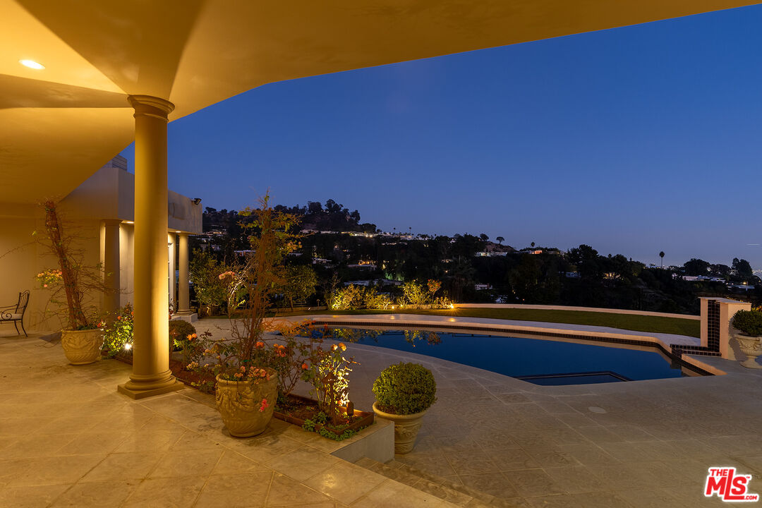 1630 Carla Ridge Beverly Hills, CA 90210 - Photo 18 of 22 a view of a lake with a car park in front of it