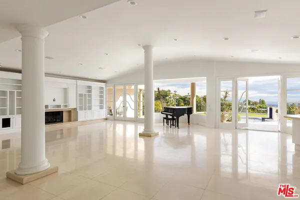 a view of a living room and a floor to ceiling window
