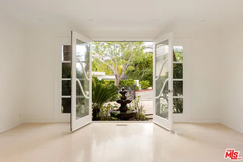 an empty room with large windows
