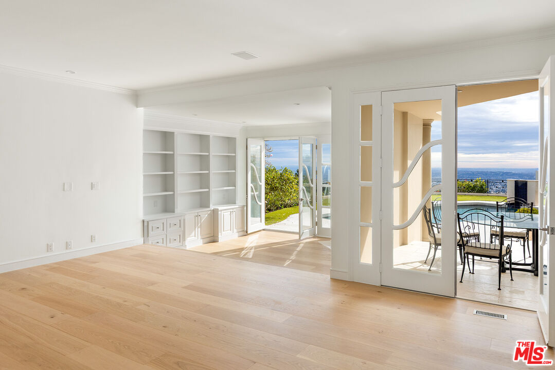 1630 Carla Ridge Beverly Hills, CA 90210 - Photo 8 of 22 a view of an empty room and a window