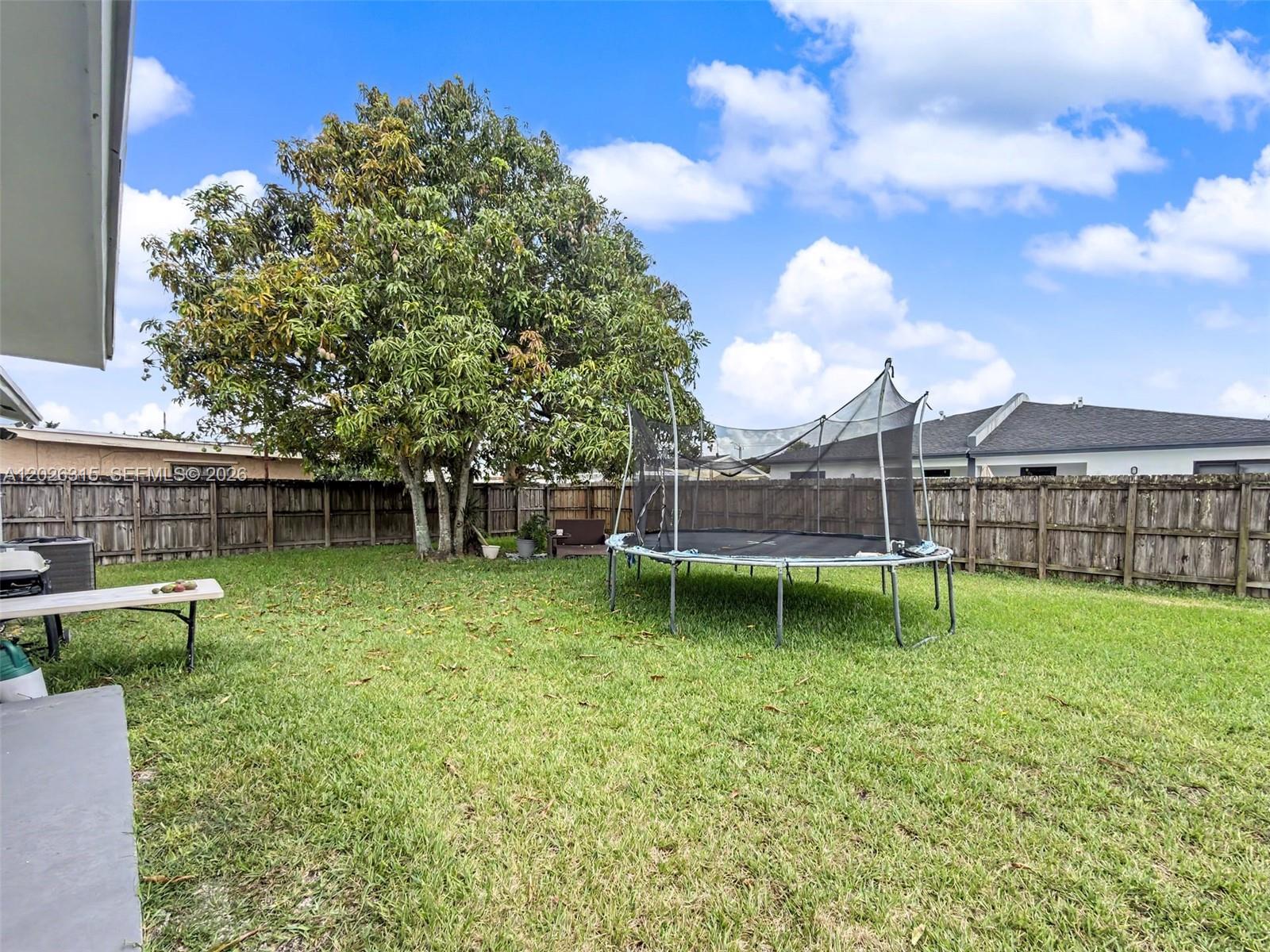 10762 Southwest 145th Street Miami, FL 33176 - Photo 27 of 28 a backyard of a house with lots of green space
