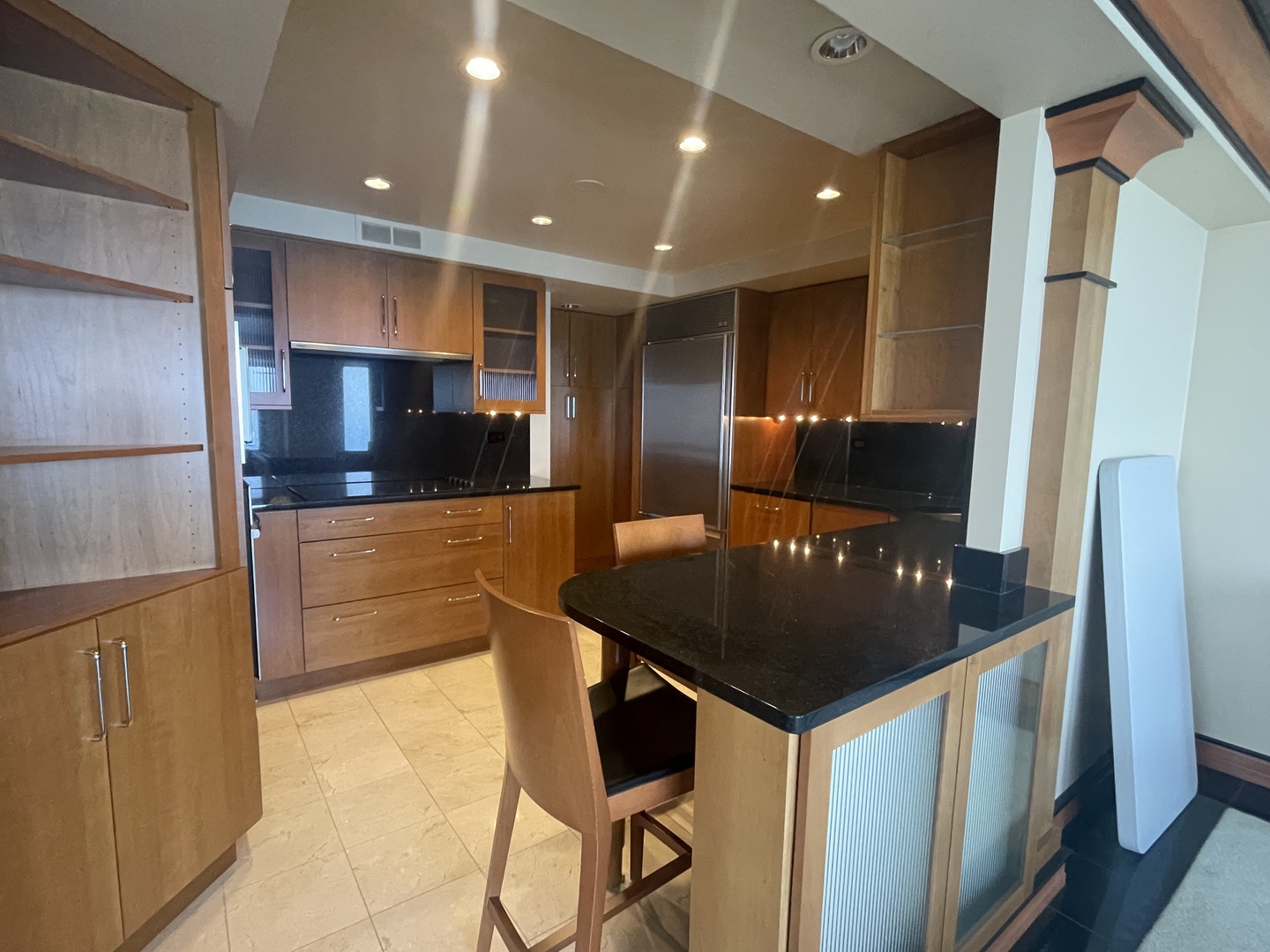 175 East Delaware Place, Unit 9007 Chicago, IL 60611 - Photo 16 of 29 a kitchen with stainless steel appliances kitchen island granite countertop a sink and a refrigerator