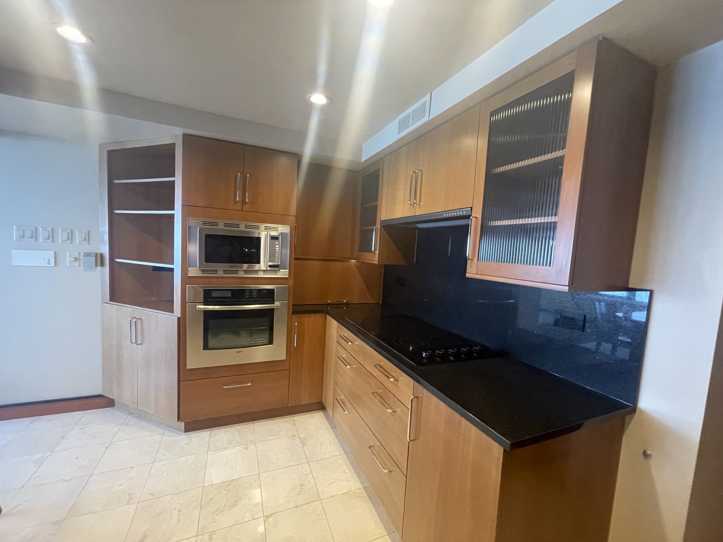 175 East Delaware Place, Unit 9007 Chicago, IL 60611 - Photo 17 of 29 a kitchen with granite countertop a stove and a refrigerator