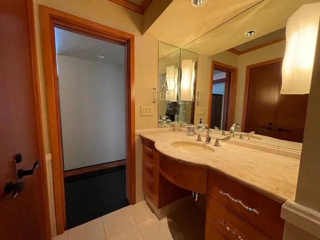 a bathroom with a toilet and a mirror