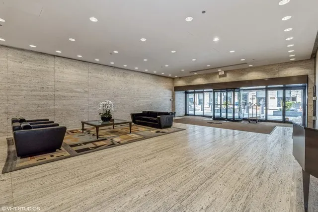 a lobby with furniture and floor to ceiling window