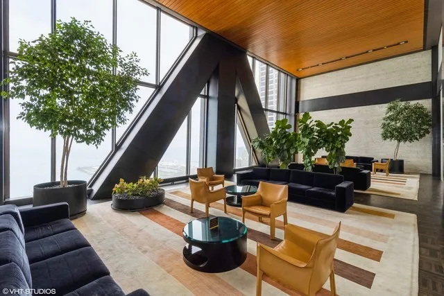 a view of balcony with chairs and potted plants