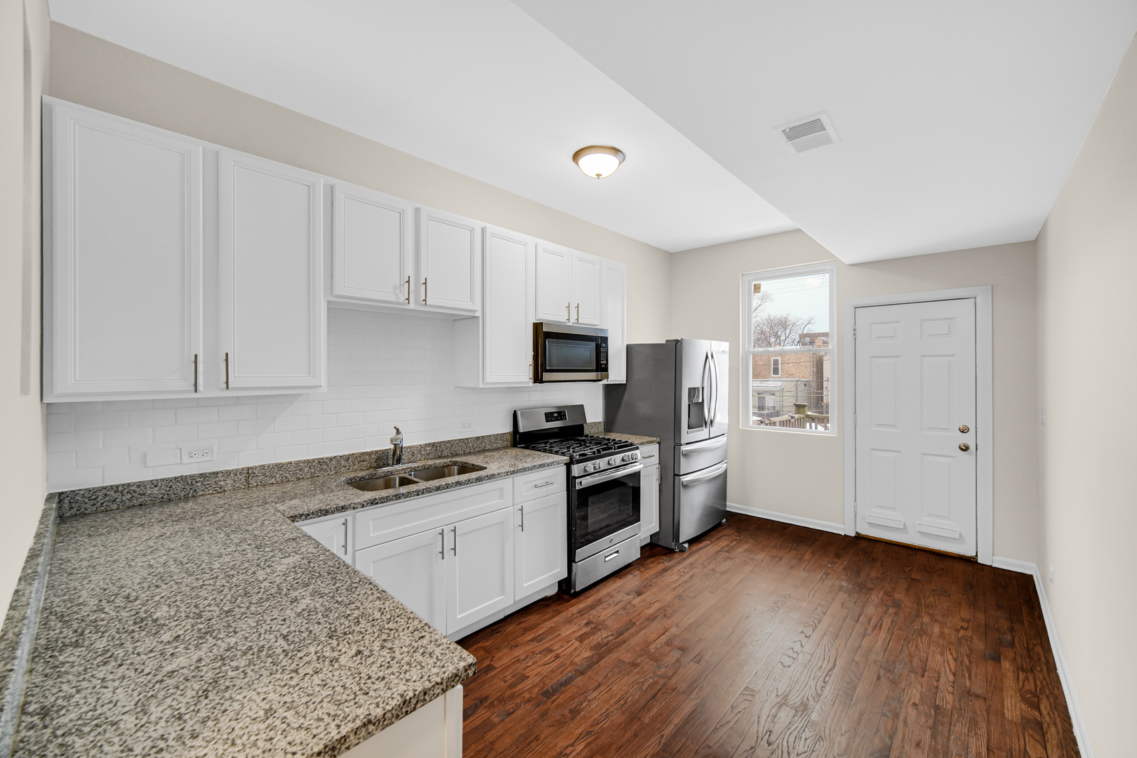 6520 South Ellis Avenue Chicago, IL 60637 - Photo 2 of 13 a kitchen with granite countertop a sink cabinets and stainless steel appliances