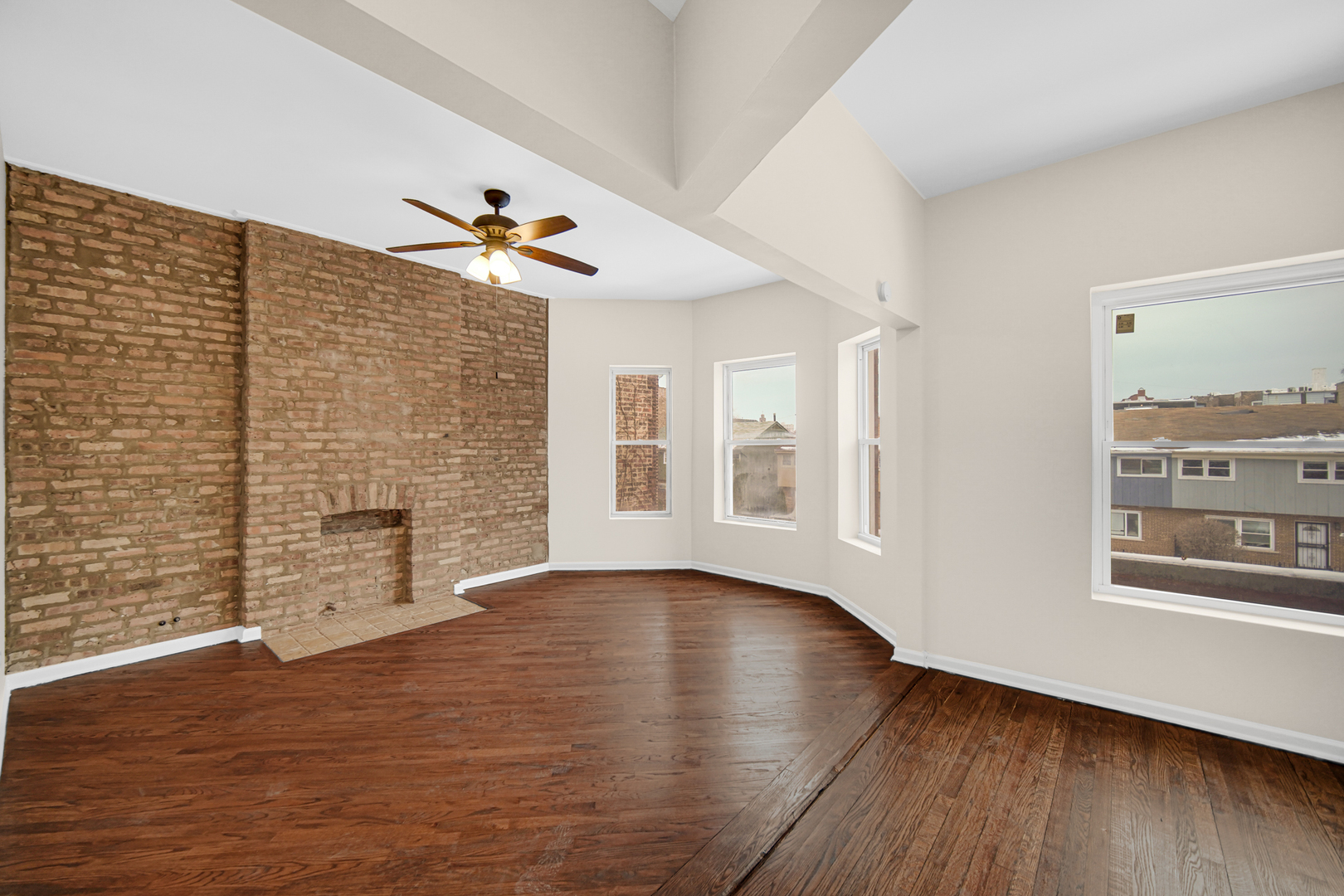 6520 South Ellis Avenue Chicago, IL 60637 - Photo 3 of 13 a view of an empty room with a window and wooden floor