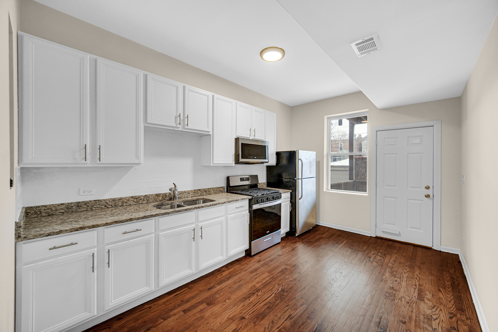 6520 South Ellis Avenue Chicago, IL 60637 - Photo 7 of 13 a kitchen with granite countertop a sink cabinets and stainless steel appliances