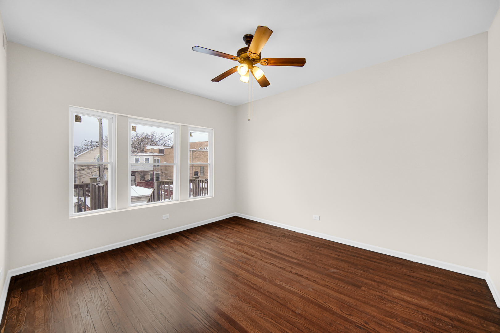 6520 South Ellis Avenue Chicago, IL 60637 - Photo 8 of 13 wooden floor in an empty room with a window