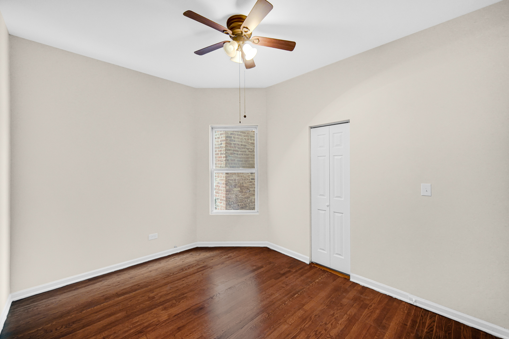 6520 South Ellis Avenue Chicago, IL 60637 - Photo 9 of 13 wooden floor in an empty room with a window