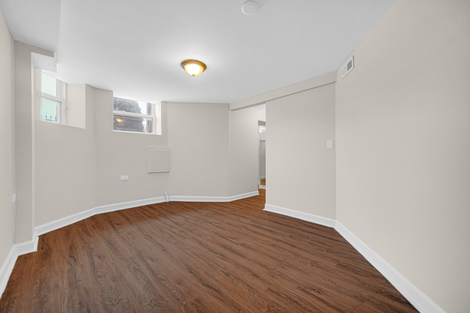 6520 South Ellis Avenue Chicago, IL 60637 - Photo 10 of 13 a view of an empty room with wooden floor