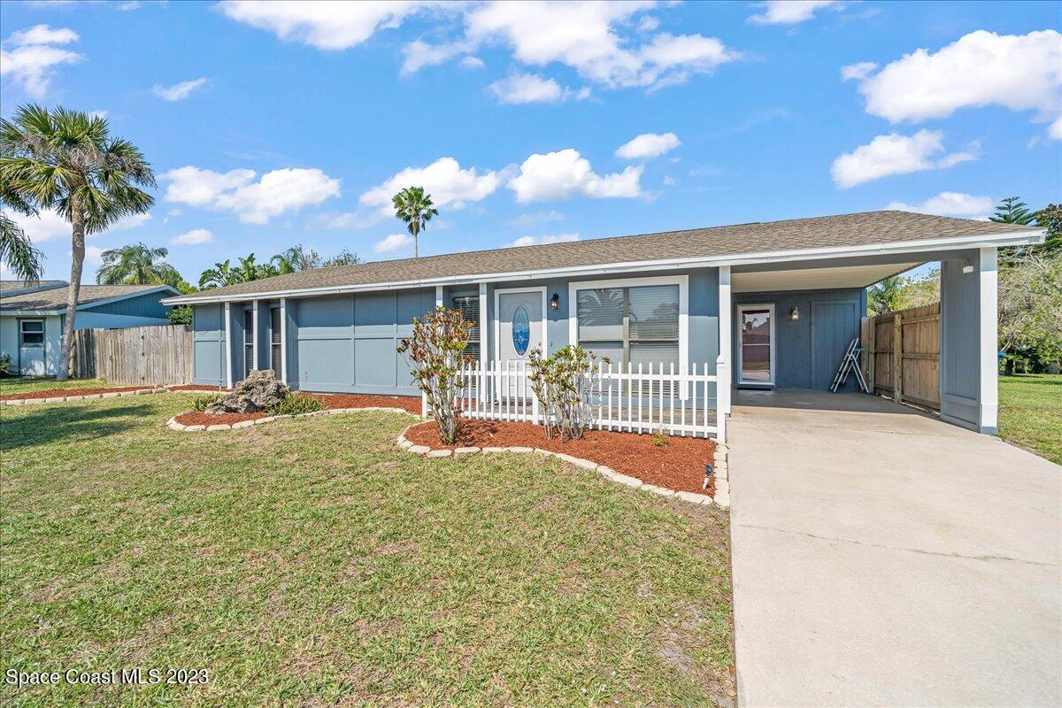 1379 Cromey Road Northeast Palm Bay, FL 32905 - Photo 1 of 25 front view of a house with a yard