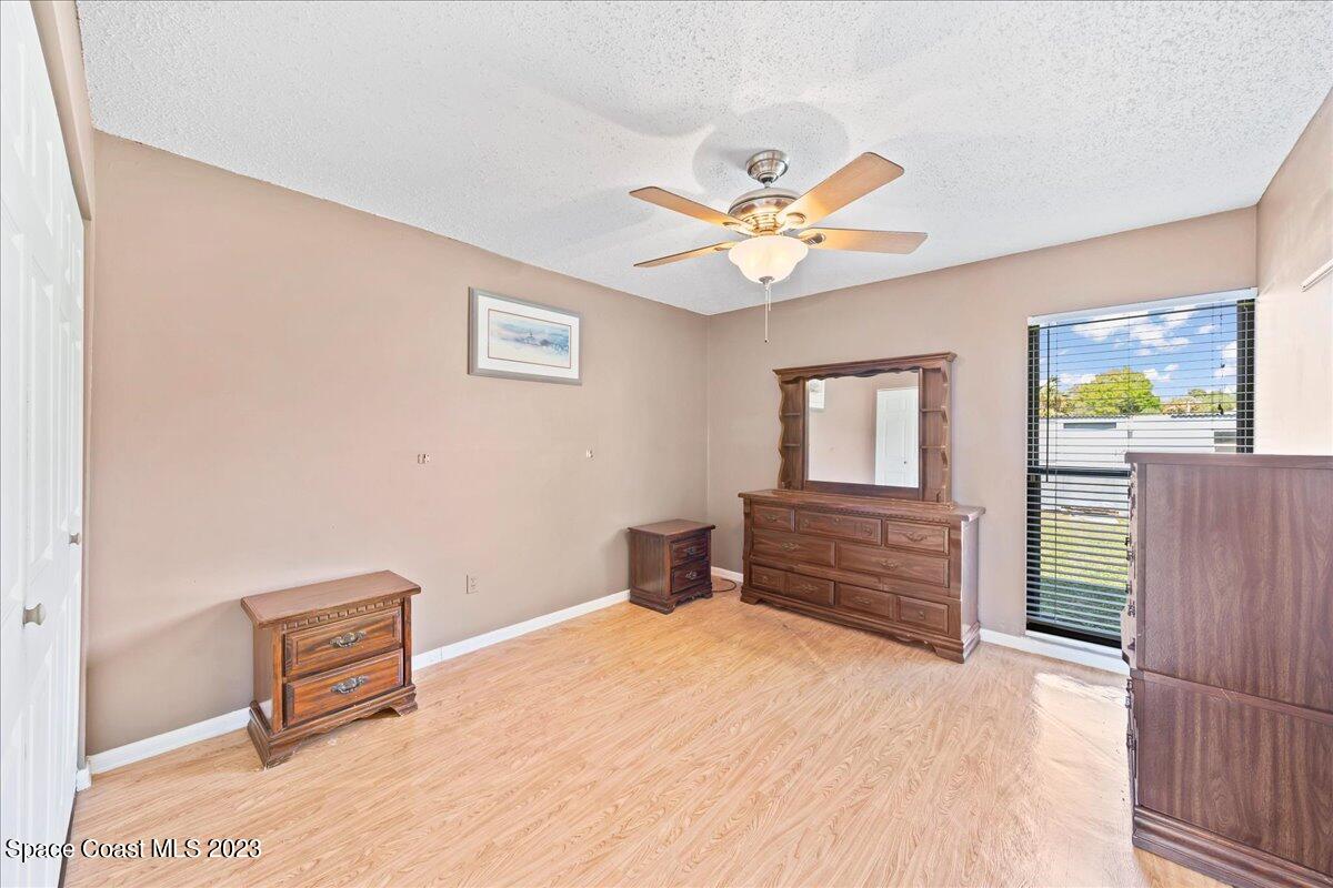 1379 Cromey Road Northeast Palm Bay, FL 32905 - Photo 12 of 25 a bedroom with a bed and furniture