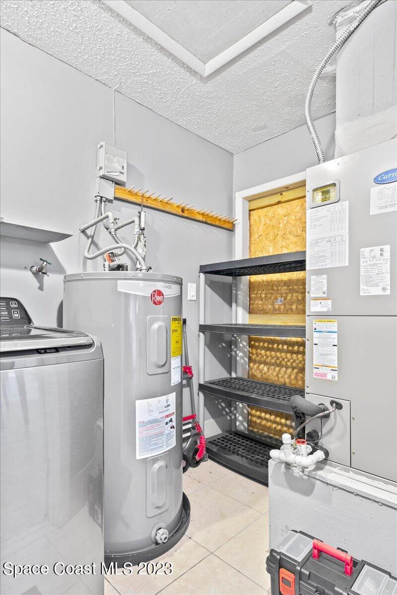 1379 Cromey Road Northeast Palm Bay, FL 32905 - Photo 20 of 25 a storage room with washer and dryer