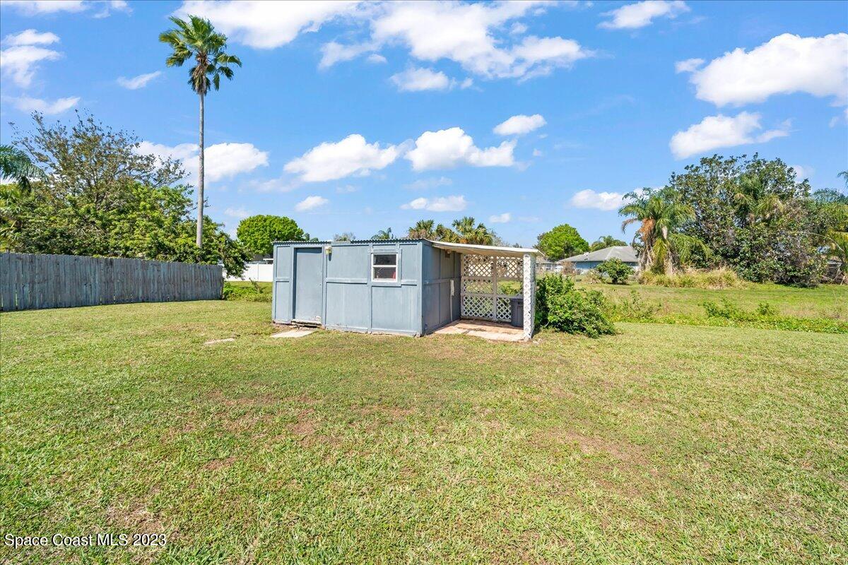 1379 Cromey Road Northeast Palm Bay, FL 32905 - Photo 22 of 25 a house view with a garden space