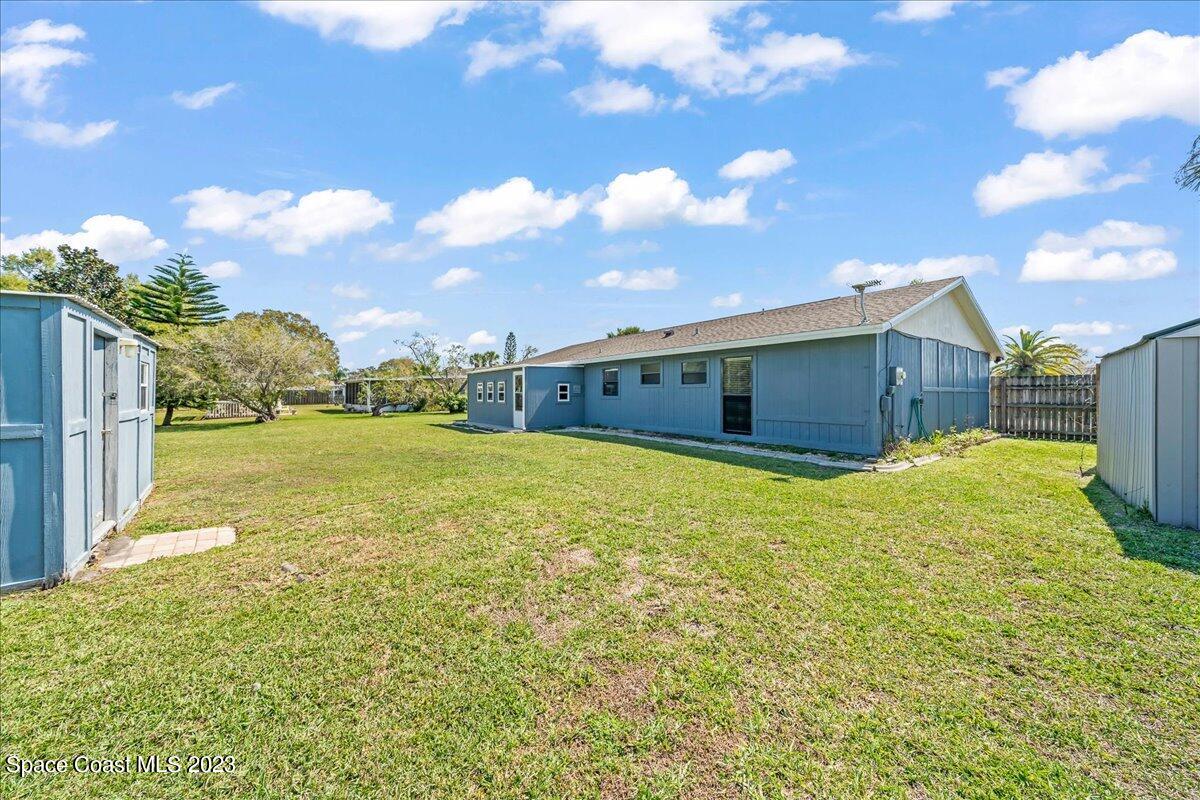 1379 Cromey Road Northeast Palm Bay, FL 32905 - Photo 23 of 25 a front view of house with yard and entertaining space