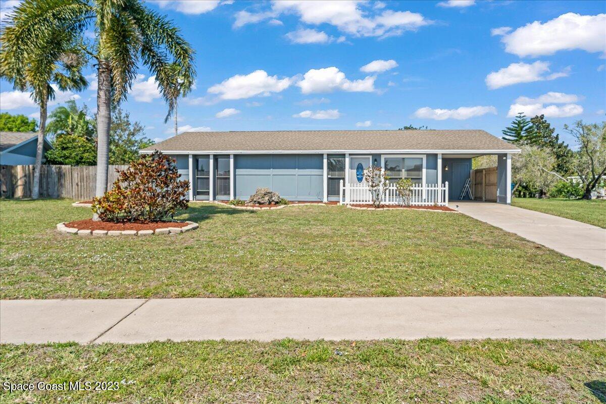 1379 Cromey Road Northeast Palm Bay, FL 32905 - Photo 3 of 25 a house view with a garden space
