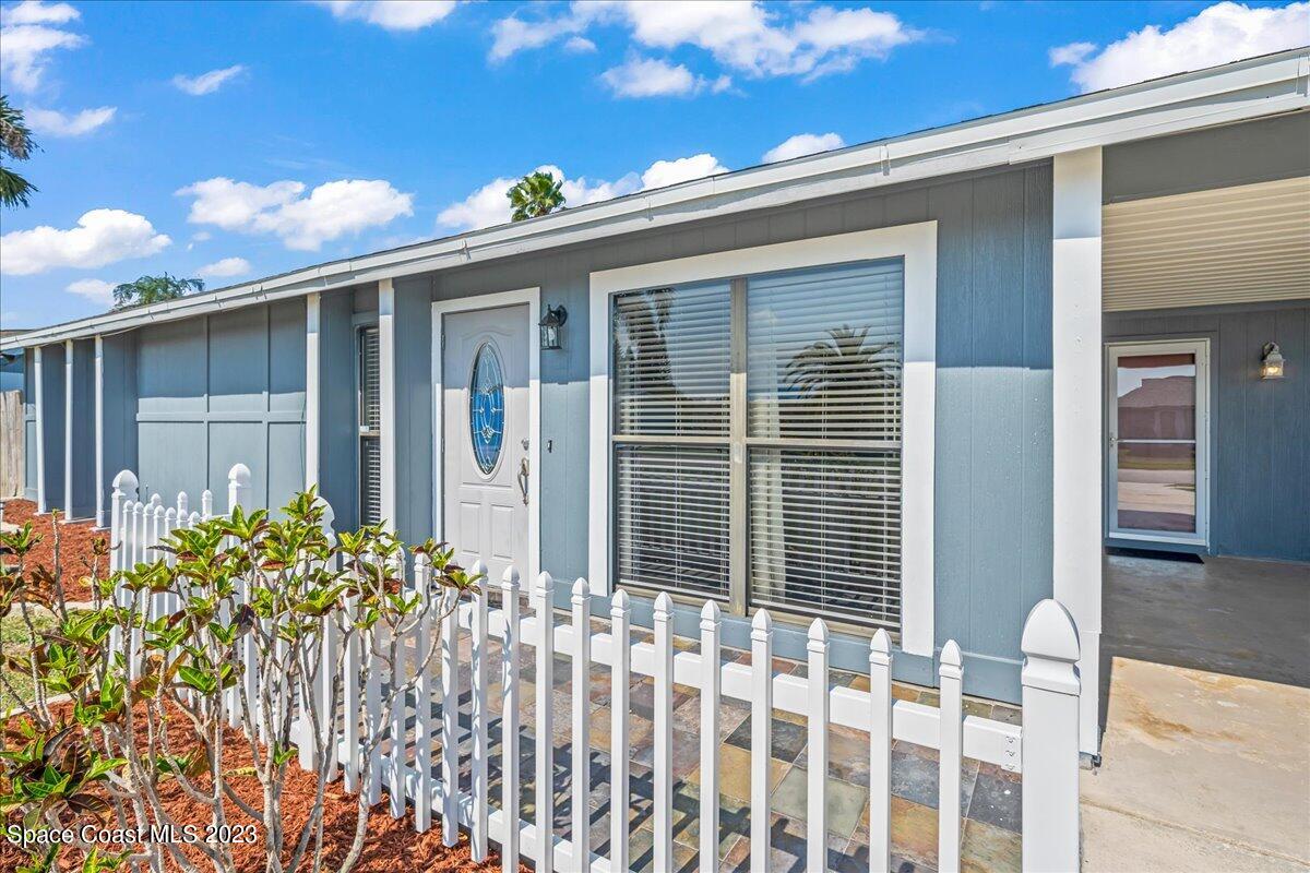 1379 Cromey Road Northeast Palm Bay, FL 32905 - Photo 4 of 25 a front view of a house with a garden