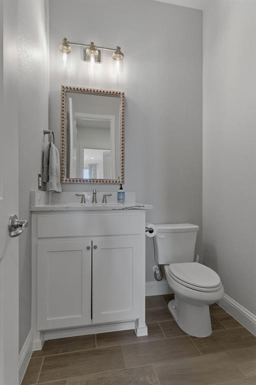 2801 Seabiscuit Road Celina, TX 75009 - Photo 14 of 39 Bathroom featuring vanity and wood tiled floors