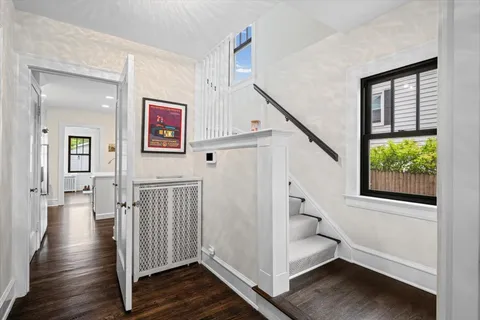 a view of entryway with stairs and wooden floor