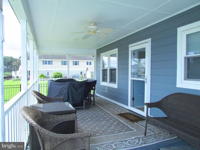 a living room with couches coffee table and chairs with outer view