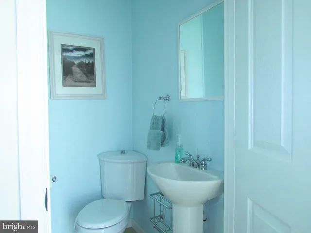 a bathroom with a sink mirror and toilet