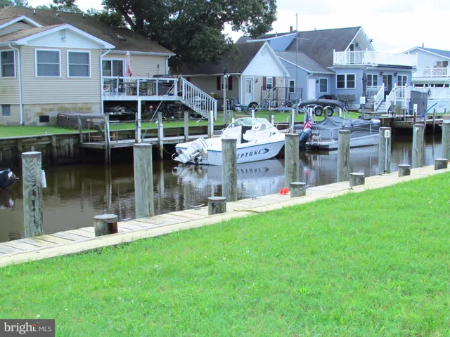 a front view of a house with a yard table and chairs