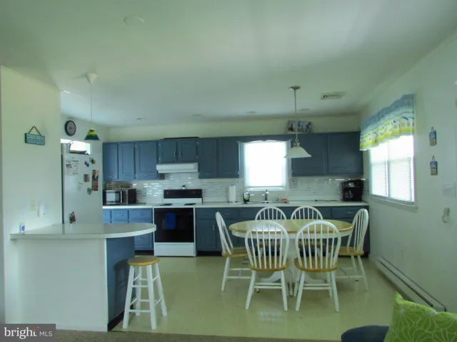a view of a dining room with furniture and window