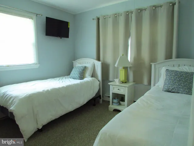 a bedroom with a bed table and window