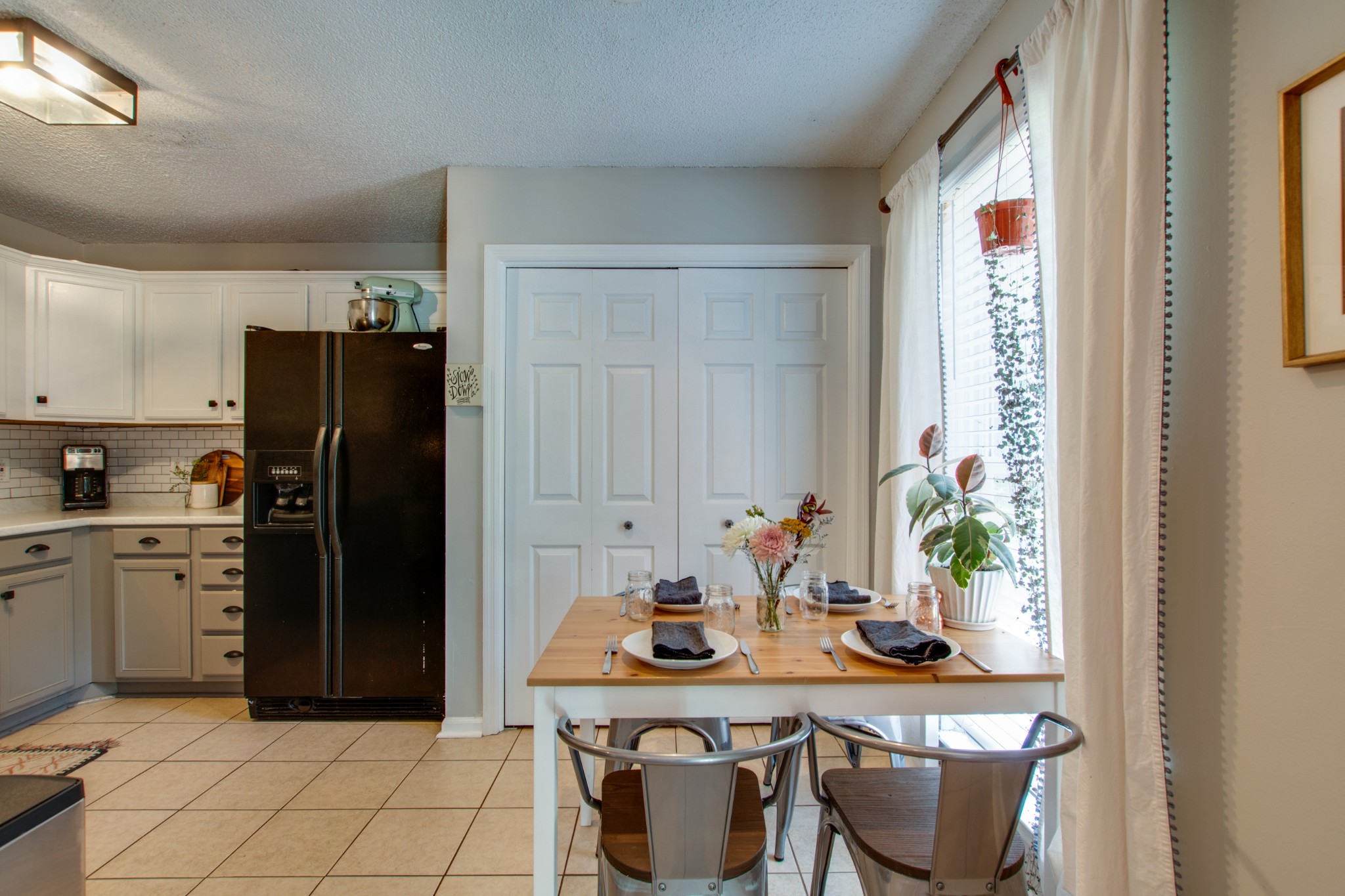 349 Cedarcliff Road Antioch, TN 37013 - Photo 11 of 27 a kitchen with stainless steel appliances granite countertop a table and a refrigerator