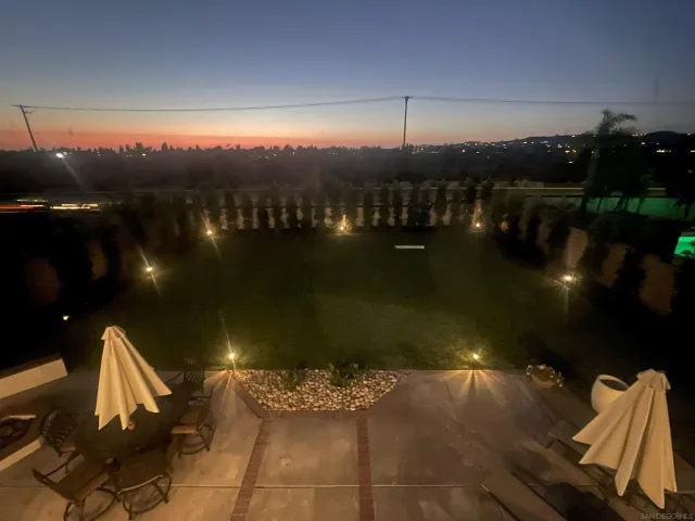 a view of a balcony with dining table and chairs