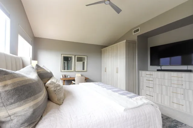 a bedroom with a bed and a flat screen tv