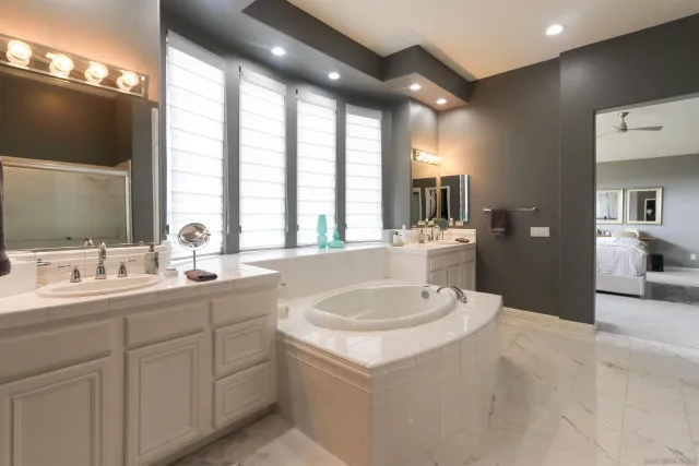 a bathroom with a double vanity sink and a mirror