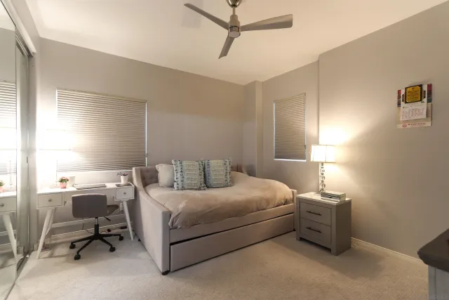 a bedroom with a bed and a chair in it