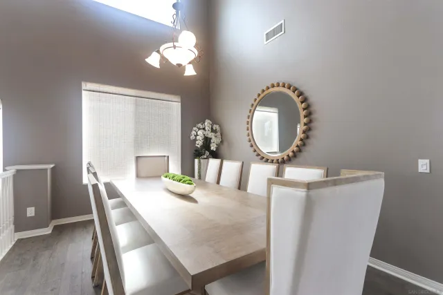 a view of a dining room with furniture and chandelier