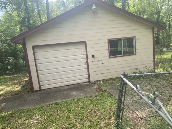 a view of house with backyard