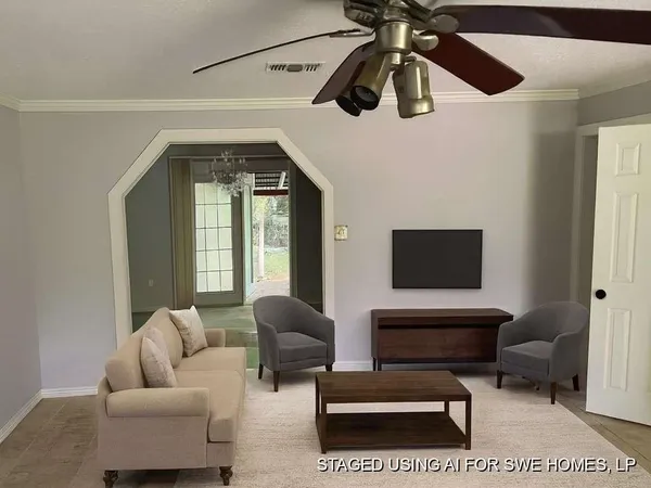 a living room with furniture and a flat screen tv