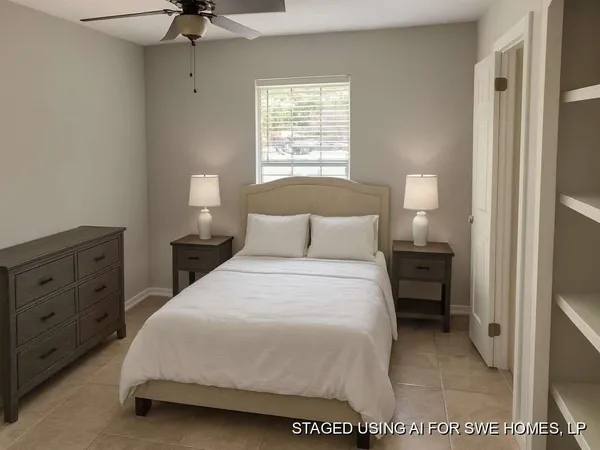 a bedroom with a bed and window