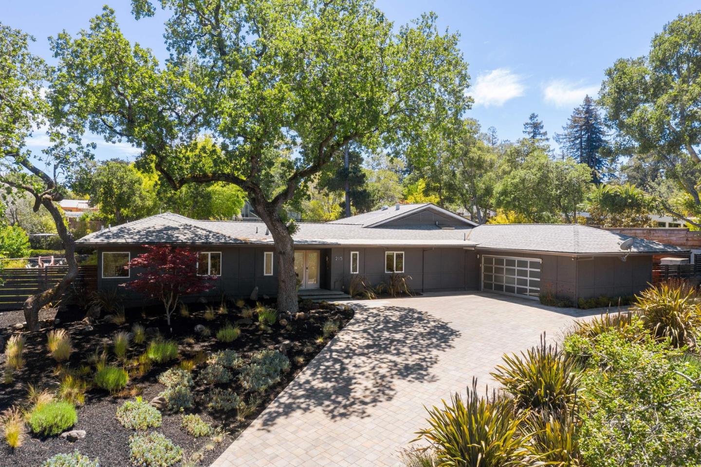 a view of a house with a yard and sitting area