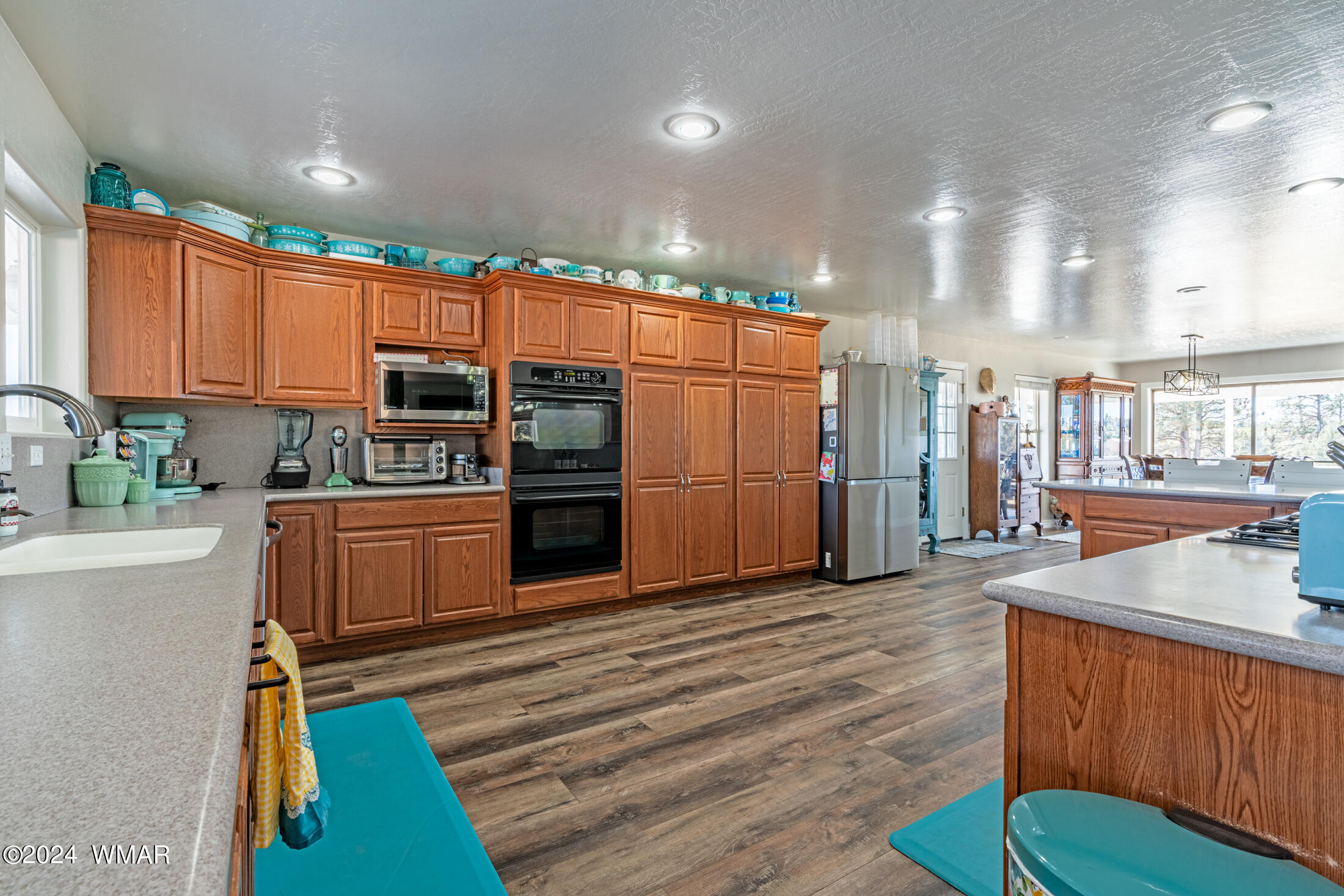 1108 Pearce Road Show Low, AZ 85901 - Photo 11 of 51 a kitchen with stainless steel appliances wooden floor dining table and chairs