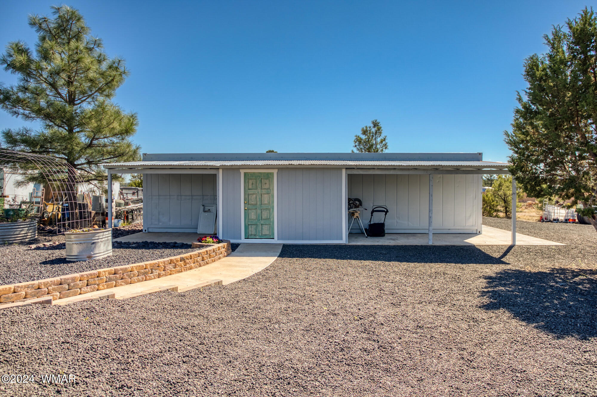 1108 Pearce Road Show Low, AZ 85901 - Photo 48 of 51 a front view of a house with a yard and garage