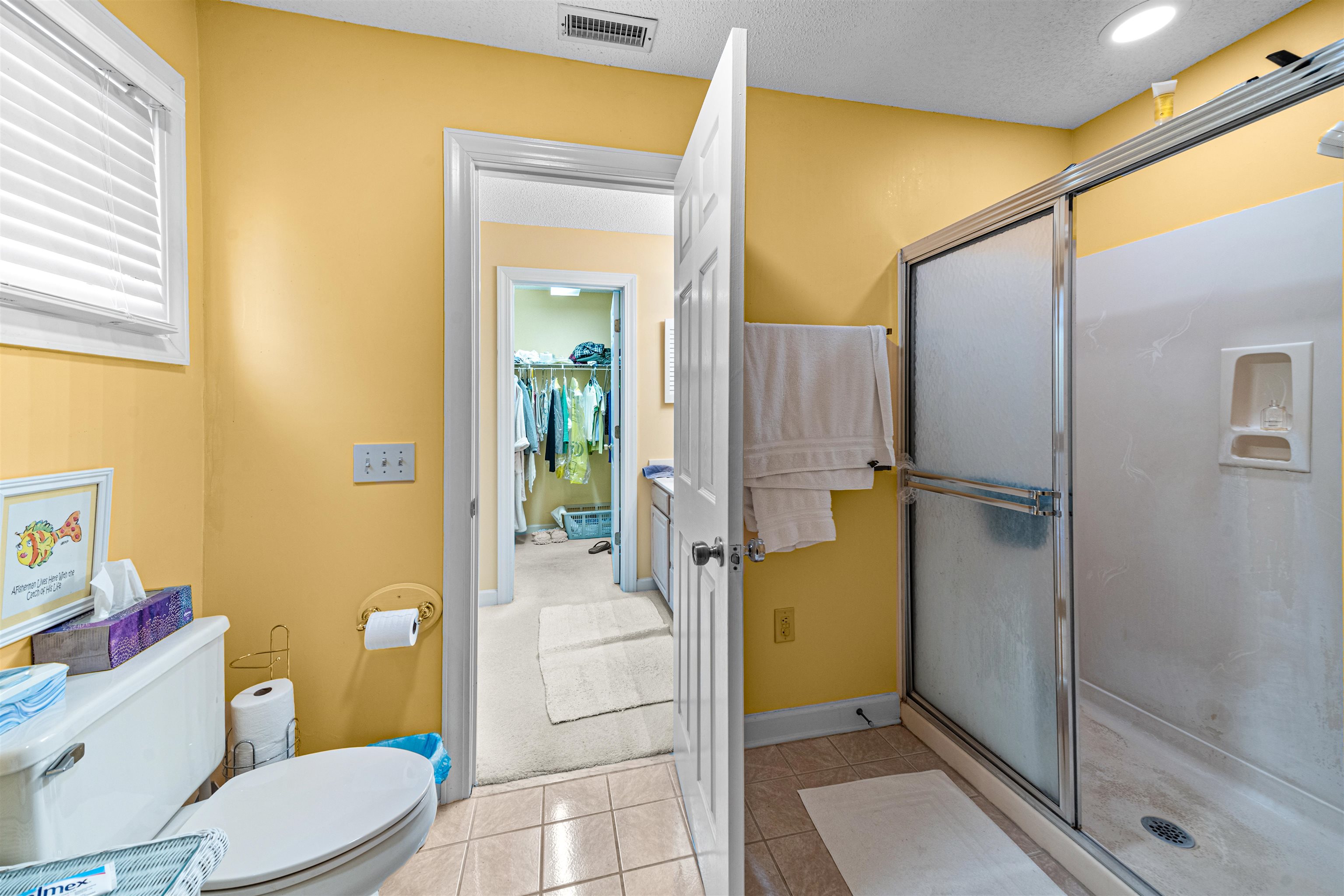 4801 Lightkeepers Way, Unit 17C Little River, SC 29566 - Photo 32 of 40 Full bathroom featuring a shower stall, light tile patterned floors, a textured ceiling, and a spacious closet