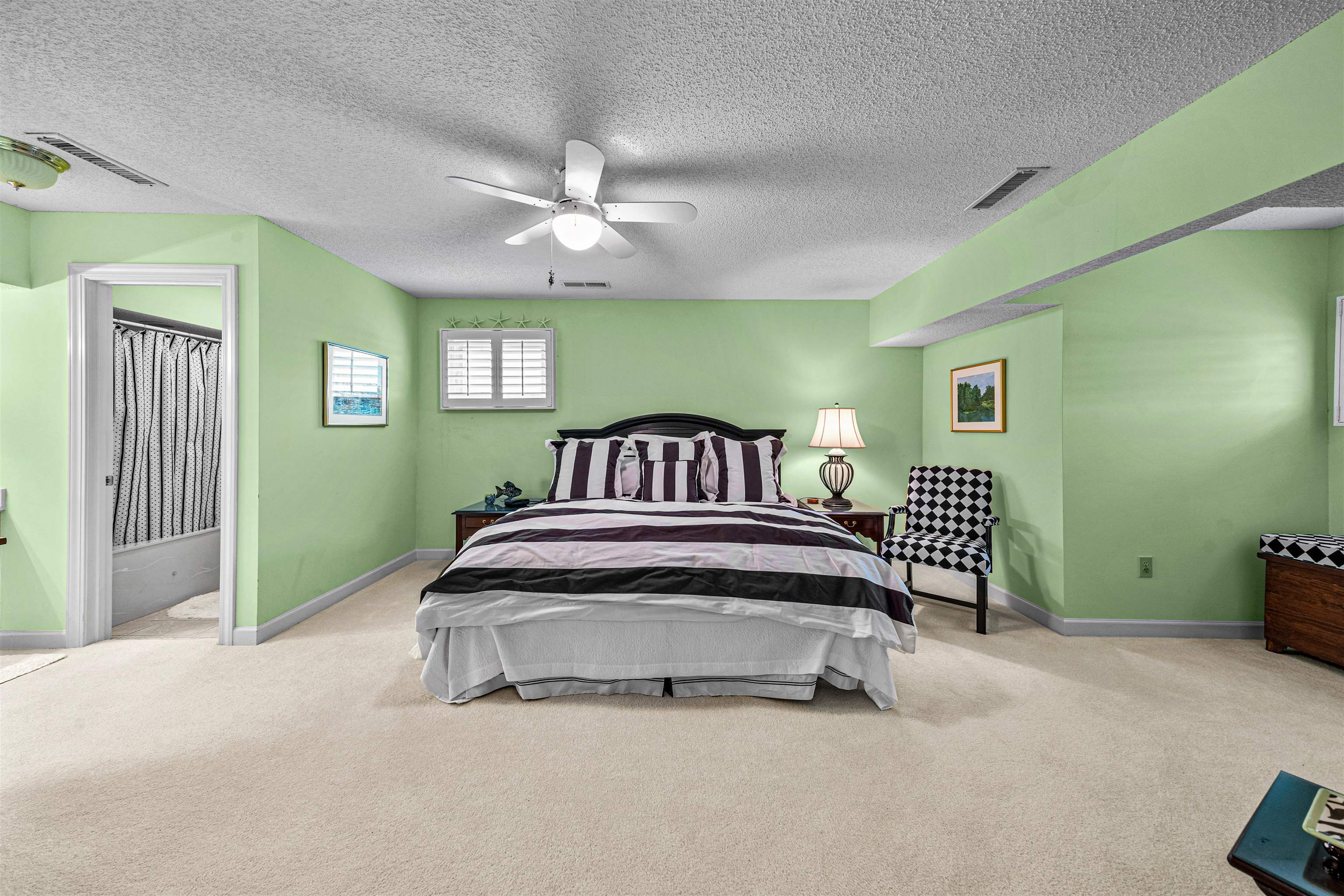 4801 Lightkeepers Way, Unit 17C Little River, SC 29566 - Photo 35 of 40 Bedroom featuring carpet, ceiling fan, a textured ceiling, and ensuite bath
