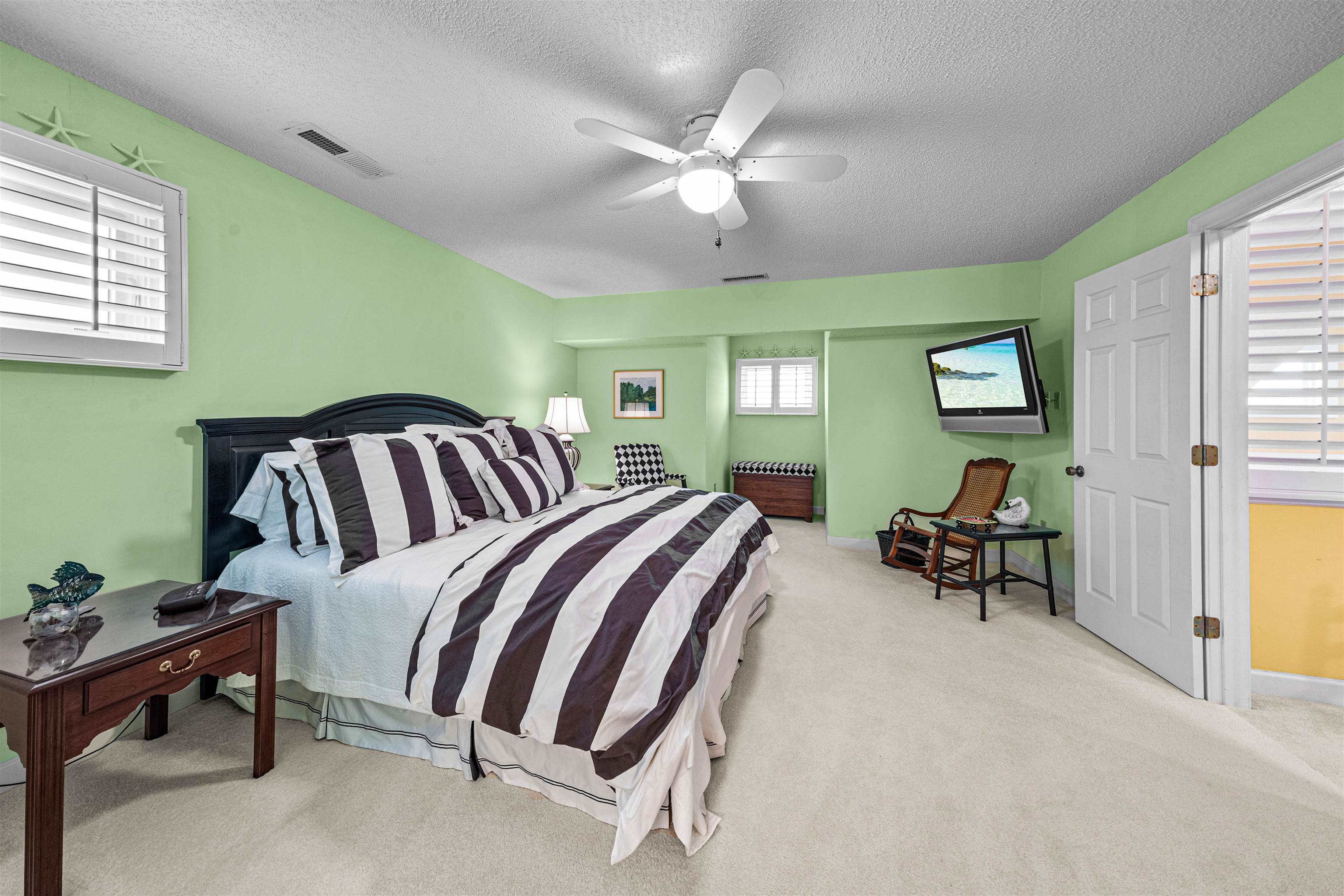 4801 Lightkeepers Way, Unit 17C Little River, SC 29566 - Photo 37 of 40 Bedroom featuring light colored carpet, a ceiling fan, and a textured ceiling