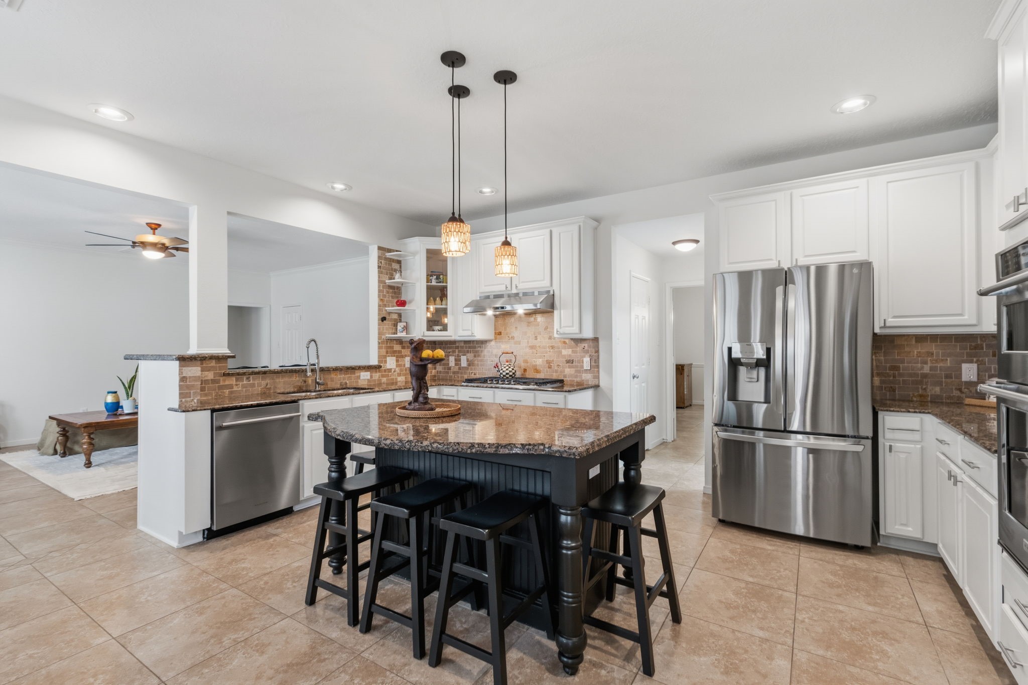8419 Marchelle Lane Spring, TX 77379 - Photo 8 of 42 a kitchen with kitchen island a dining table chairs stainless steel appliances and cabinets